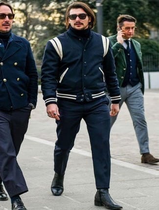 Guy wearing a varsity jacket in an elegant style